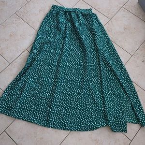 Green long skirt with a slit. Has white flower details, size Large from SHEIN